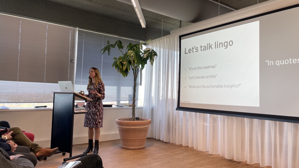 Photo of Janelle Ward speaking, with slide showing 'Let's talk lingo'