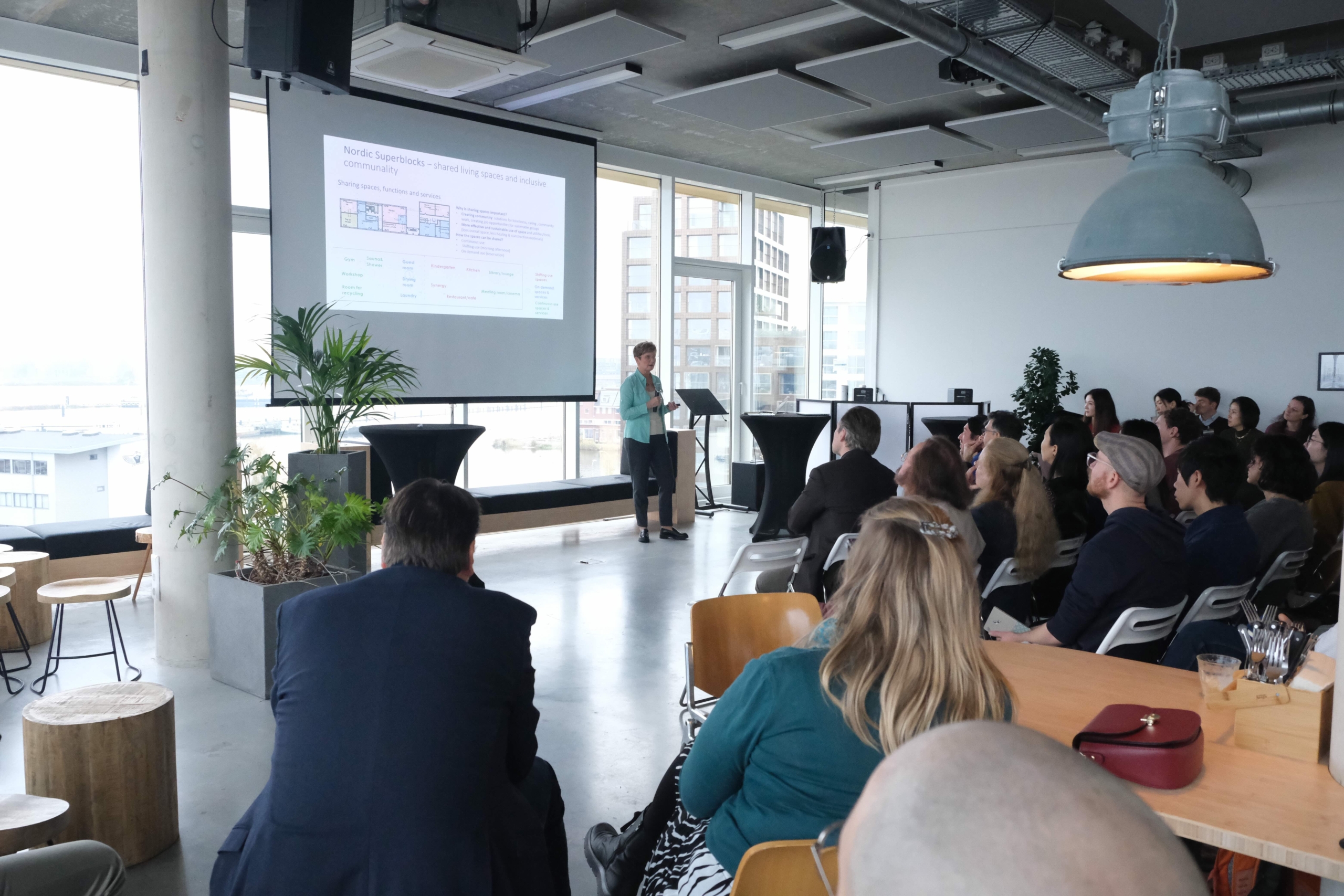 Professor Kaisa Väänänen speaking, with part of the audience visible from behind