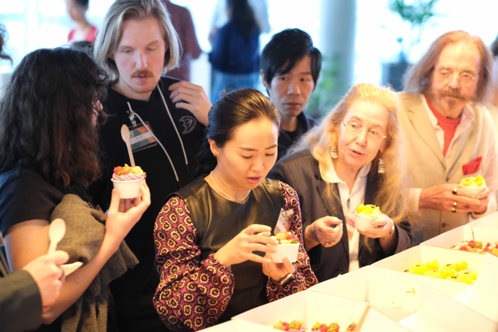 People helping themselves to a cake